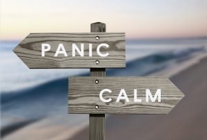 Calm vs Panic signs with blurred beach background